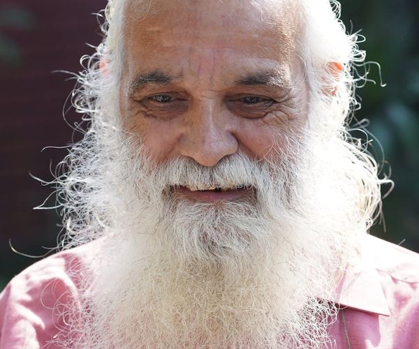 Content senior man meditating with a calm expression on his face.